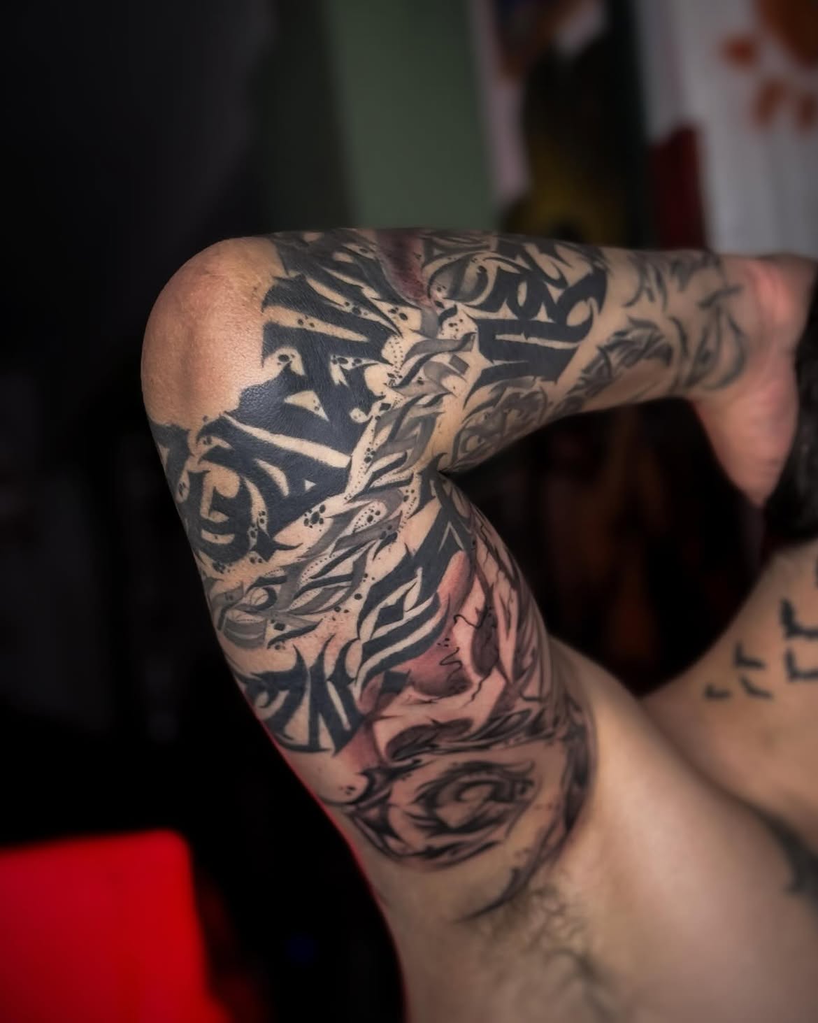 Black ink calligraphy tattoo by Groc at Sage Tattoo Studio Tel Aviv