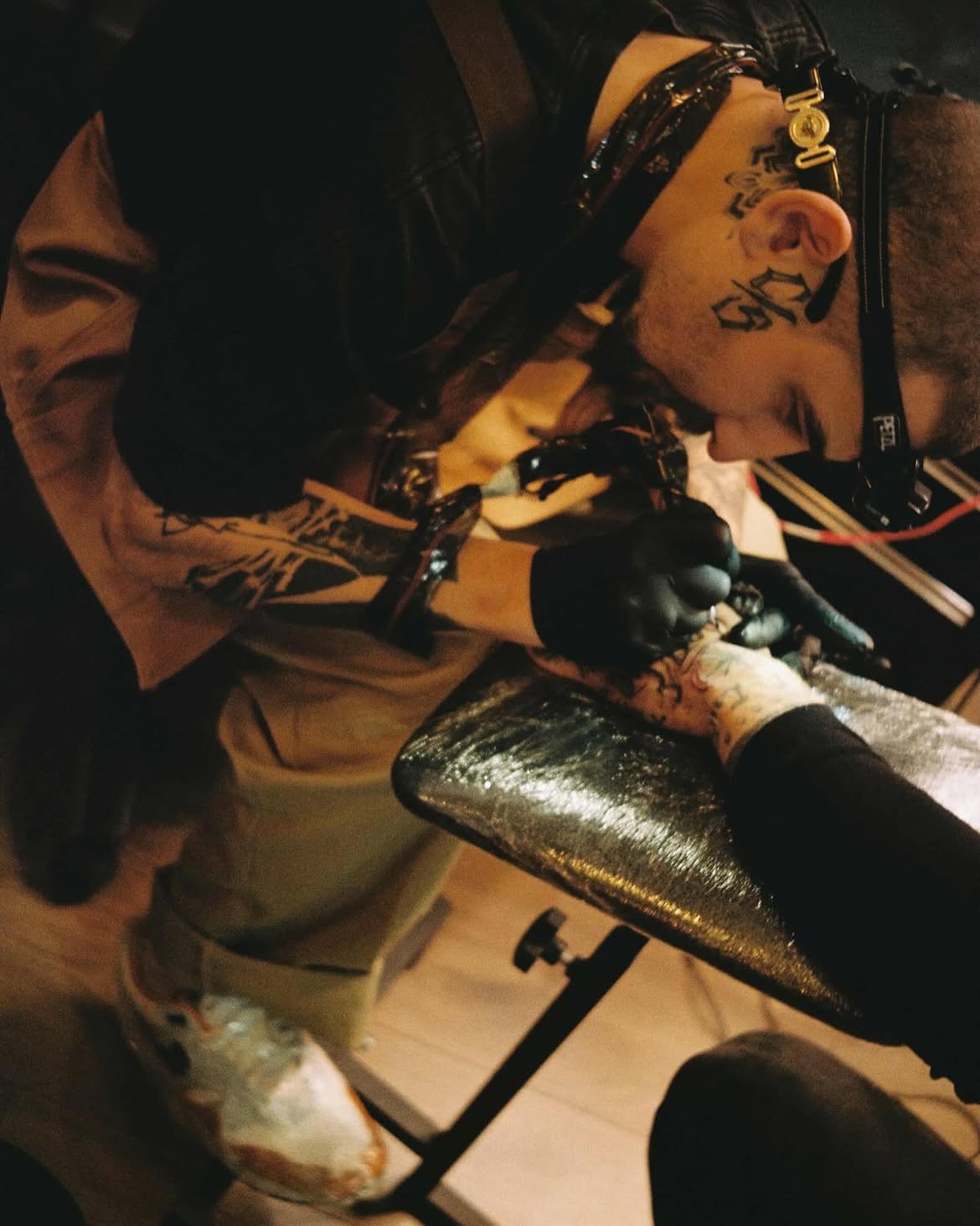 Black ink flowing script by Groc, tattoo in Tel Aviv