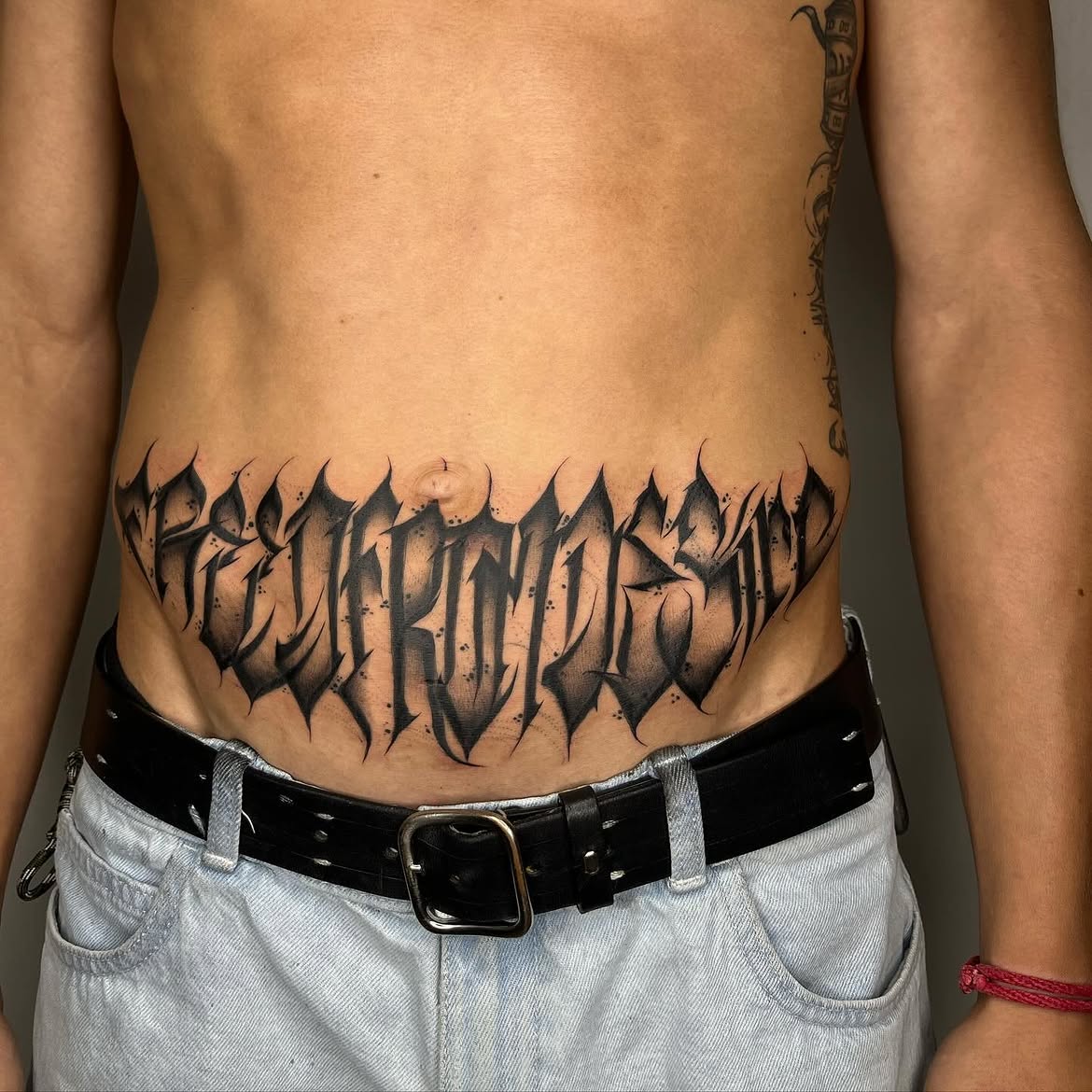 Bold script work by Groc — tattoo tel aviv